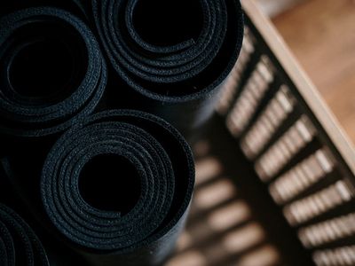 Close-up of a rolled yoga mat and water bottle.