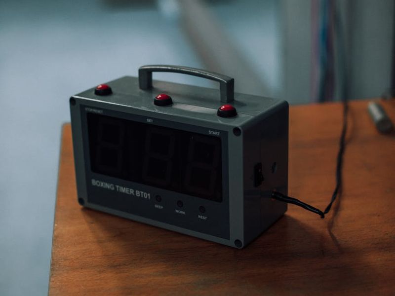 Close up of sports equipment like a timer and mat.
