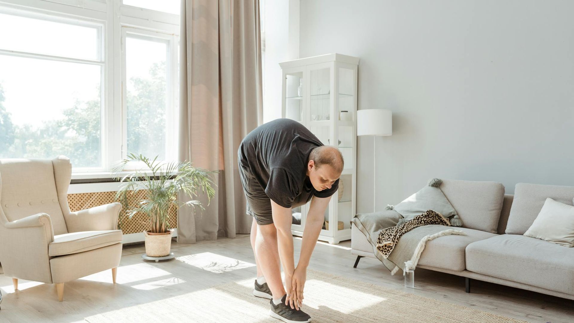 Person doing morning exercises in a bright minimalist room.